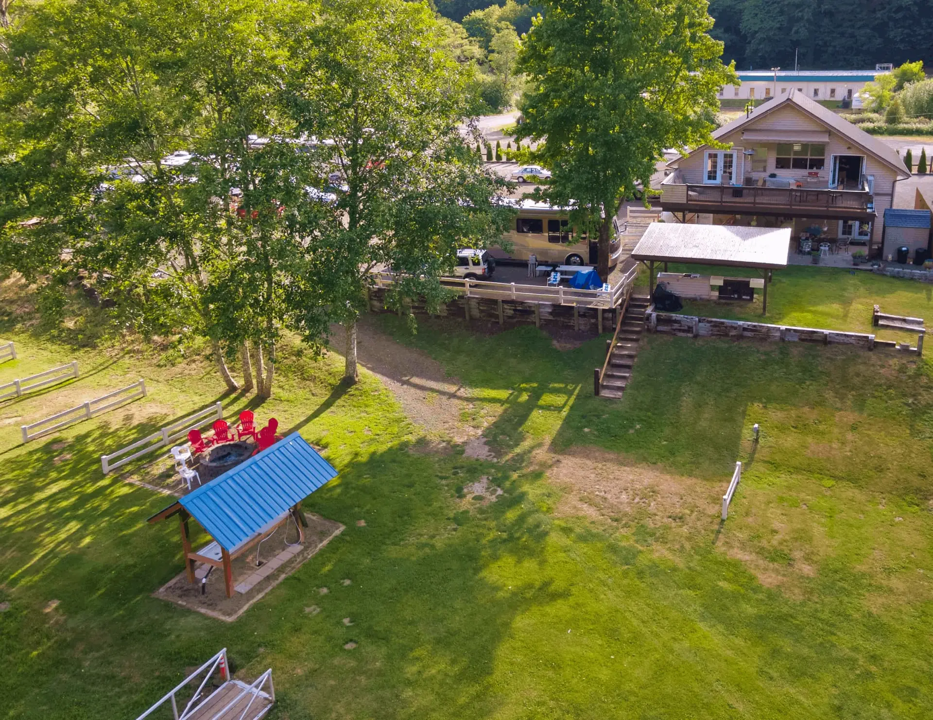 An aerial view of Maple Lane RV Park and Marina, east of Florence on the Oregon Coast, showing RVs, a house, and green lawns.